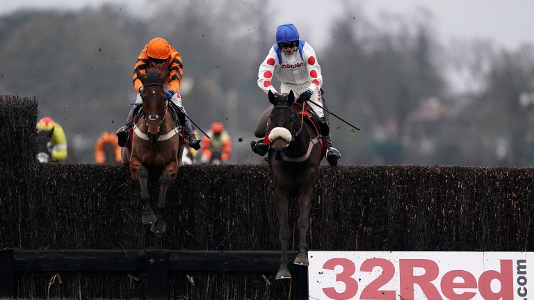 Clan Des Obeaux (right) heads Thistlecrack at the last in the King George at Kempton