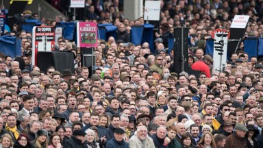 Racegoers cheer at the start of the Triumph hurdleCheltenham 17.3.17 Pic: Edward Whitaker