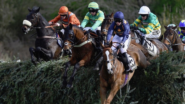 LIVERPOOL, ENGLAND - APRIL 08: Eastlake (centre) ridden by Barry Geraghty jumps Canal Turn behind leader Fairy Rath ridden by Tom Cannon during The Crabbies Topham Steeple Chase at Aintree Racecourse on April 8, 2016 in Liverpool, England. (Photo by La