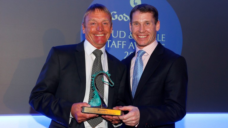 Colin Nutter (left), 45 years head man to Sir Mark Prescott, receives the dedication to racing award from Richard Johnson at the Godolphin Stud and Stable Awards in February