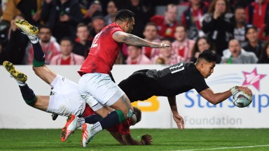 New Zealand winger Rieko Ioane scores the first of his two tries against the Lions