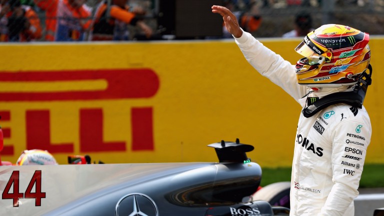 Lewis Hamilton celebrates after grabbing pole position