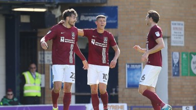 SOUTHEND, ENGLAND - SEPTEMBER 16:Matt Crooks of Northampton Town is congratulated by team mates Alex Revell and Ash Taylor after scoring his sides second goal during the Sky Bet League One match between Southend United and Northampton Town at Roots Hall o
