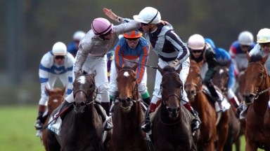 Thierry Gillet (striped sleeves) and Bago are the toast of Longchamp after the 2004 Arc