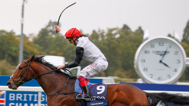 Dettori raises his whip in triumph passing the post in the Champion Stakes