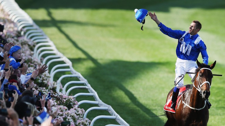MELBOURNE, AUSTRALIA - OCTOBER 28:  Hugh Bowman throws his helmet into the crowd on returning to scale after winning on Winx to win race 9 the Ladbrokes Cox Plate during Cox Plate Day at Moonee Valley Racecourse on October 28, 2017 in Melbourne, Australia