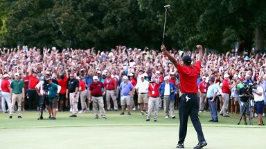 Tiger Woods celebrates sinking his par putt to win the TOUR Championship