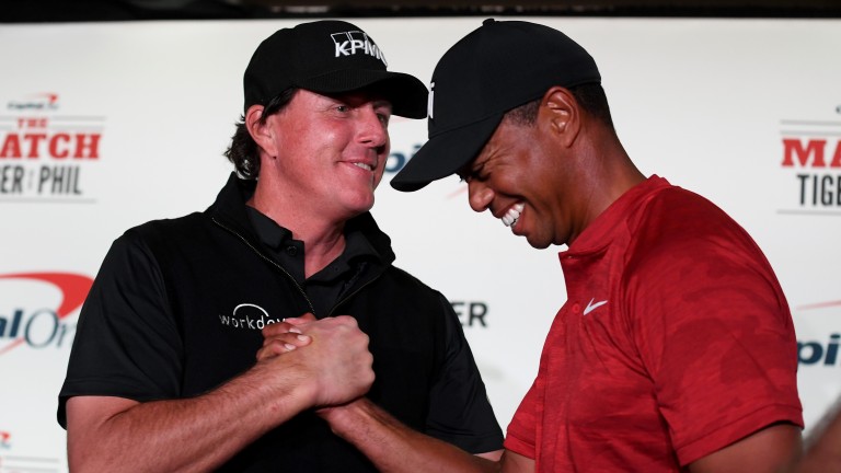 Phil Mickelson and Tiger Woods shake hands at a Shadow Creek media conference