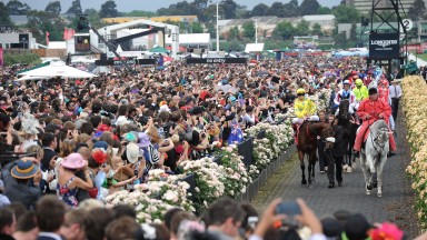 MELBOURNE, AUSTRALIA - NOVEMBER 06: Craig Williams riding Dunaden leads the field out to the barriers in the Emirates Melbourne Cup during 2012 Melbourne Cup Day at Flemington Racecourse on November 6, 2012 in Melbourne, Australia.  (Photo by Vince Caligi