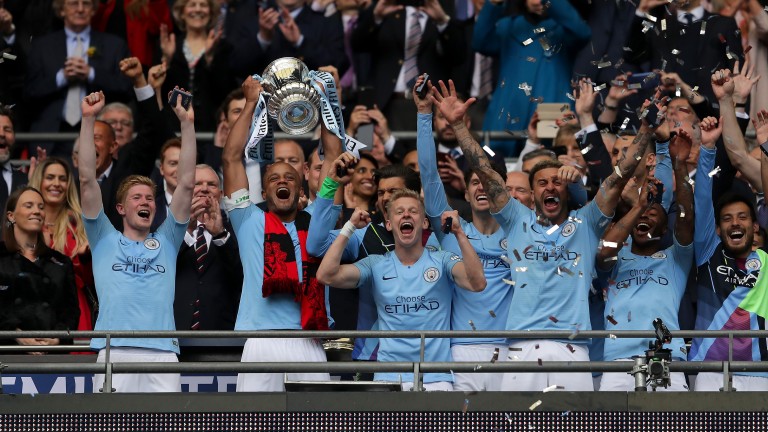 Vincent Kompany of Manchester City lifts the FA Cup trophy