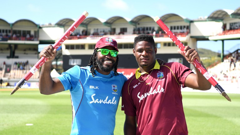 Oshane Thomas (right) and Chris Gayle celebrate victory over England in St Lucia