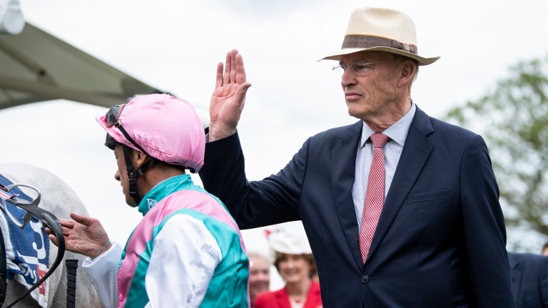 John Gosden hits Frankie Dettori on his cap after the jockey had performed his flying dismount from Logician when winning the Great Voltigeur Stakes