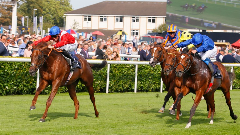 Threat (left) wins the Champagne Stakes under Pat Dobbs at Doncaster