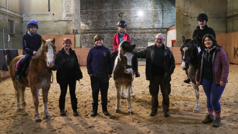 Staff and pupils are all smiles in the riding arena