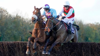 CHEPSTOW, WALES - OCTOBER 27: Adrian Heskin riding The Wolf (L, blue) clear the last to win The CD Racing At tipstersempire.co.uk Beginners' Chase at Chepstow Racecourse on October 27, 2020 in Chepstow, Wales. Owners are allowed to attend if they have a r