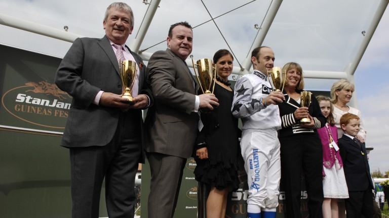 Phil Cunningham (second from left) and connections of Cockney Rebel collect their trophies at Newmarket