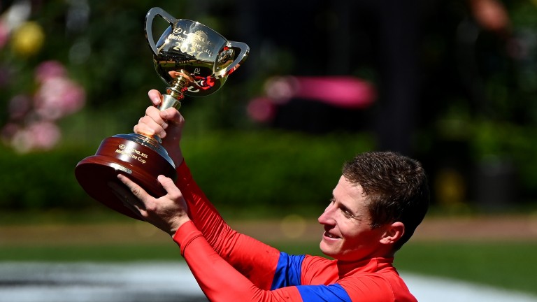 James McDonald: lifts the Melbourne Cup trophy