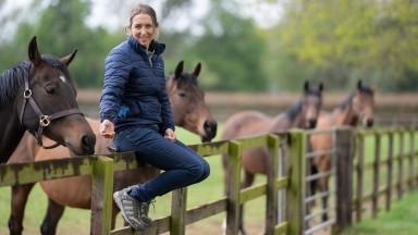 Natasha Halliday , owner of Marston Stud sits on the fence overlooking a paddock full of maresBanbury 25.4.22 Pic: Edward Whitaker