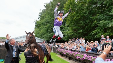 Frankie Dettori performs a flying dismoint from Lezoo after the filly had won the Maureen Brittain Memorial Empress Fillies' Stakes as Dettori's only ride at Newmarket the day after news of his 'sabbatical' from riding for John Gosden broke