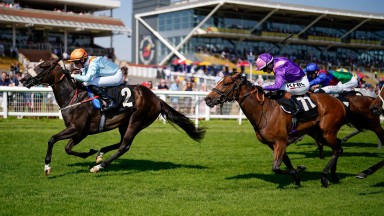 NEWBURY, ENGLAND - AUGUST 12: Ross Coakley riding Cuban Mistress (L) win The BetVictor St Hugh's Stakes at Newbury Racecourse on August 12, 2022 in Newbury, England. (Photo by Alan Crowhurst/Getty Images)