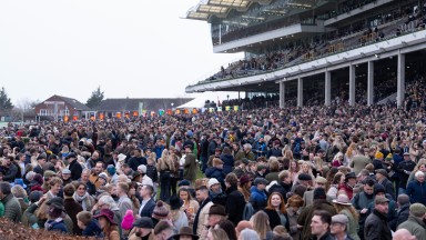 A bumper crowd wait to greet Midnight River (Harry Skelton) after their win in the 2m 4.5f handicap chaseCheltenham 1.1.23 Pic: Edward Whitaker